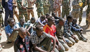 A group of young Boko Haram militants sits on the ground in Ngouboua, Chad, after surrendering to the Chadian army after been kidnapped by Boko Haram in Northern Nigeria. Some of the militants were as young as 12 years old. Refugees and child soldiers who have escaped Islamist militants in Nigeria are fleeing to Chad. TOMASO CLAVARINO